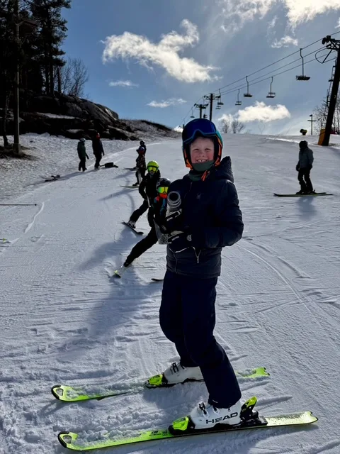 kid posing on the ski hill