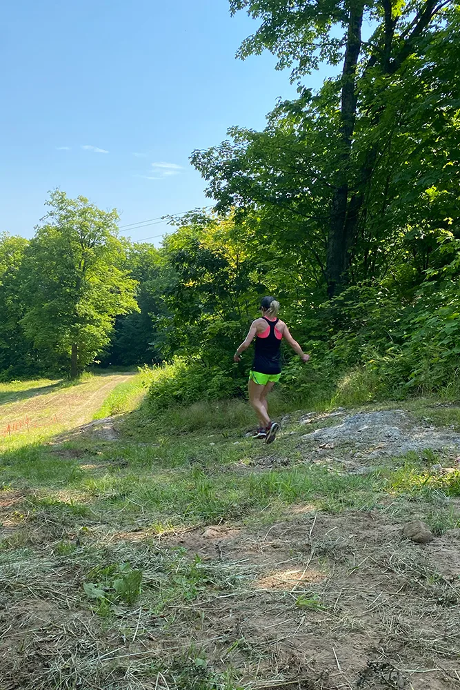 Woman hiking down hill at Rocket Hill Climb