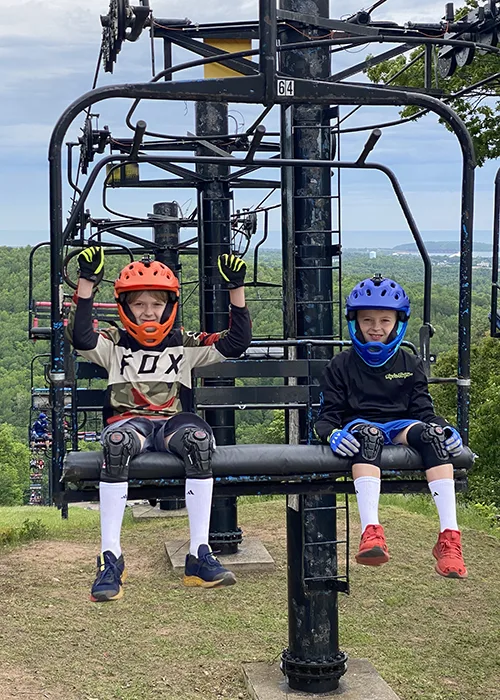 2 Young Boys In Bike Gear At The Top Of The Chair Lift 2 Young Boys In Bike Gear At The Top Of The Chair Lift