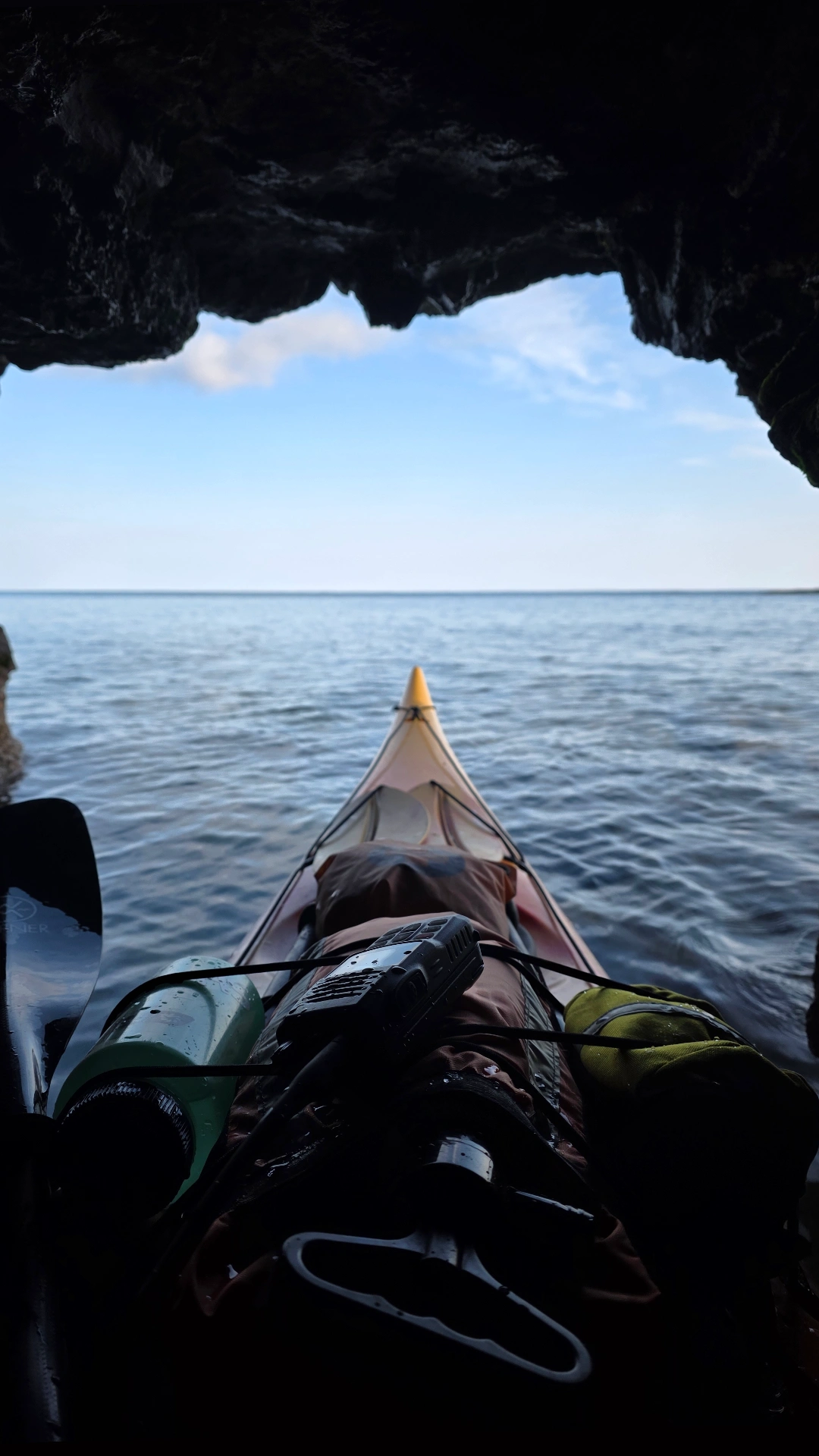 Sea kayak leaving cave on Lake Superior